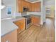 Modern kitchen features stainless steel appliances, wooden cabinets, and hardwood floors at 15604 Waterfront Dr, Huntersville, NC 28078
