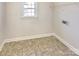 Functional laundry room featuring tile flooring, a window, and utility connections at 15604 Waterfront Dr, Huntersville, NC 28078