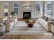 Bright living room with fireplace, hardwood floors, and plush furnishings, perfect for relaxing and entertaining at 15604 Waterfront Dr, Huntersville, NC 28078