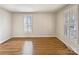 Bright living room features wood floors and plantation shutters at 15604 Waterfront Dr, Huntersville, NC 28078