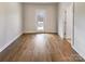 Empty room with hardwood floors and a rear door at 15604 Waterfront Dr, Huntersville, NC 28078