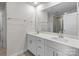 Bright bathroom featuring double vanity with white cabinets, stone counters, and modern fixtures at 2116 Belterra Dr, Charlotte, NC 28216