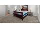 Comfortable bedroom with carpet, large bed, and ensuite bathroom access at 2116 Belterra Dr, Charlotte, NC 28216