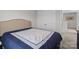 Bedroom featuring Queen-size bed with white and navy blue bedding and double door closet at 2116 Belterra Dr, Charlotte, NC 28216
