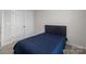 Bedroom with dark blue bed set, carpet and double door closet at 2116 Belterra Dr, Charlotte, NC 28216