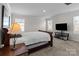 Cozy bedroom with a comfortable bed, bedside table, and ample natural light at 2116 Belterra Dr, Charlotte, NC 28216