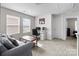 Bright, carpeted bonus room with sofa, desk and large window with blinds at 2116 Belterra Dr, Charlotte, NC 28216