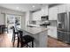 Modern kitchen featuring white cabinets, stainless steel appliances, and a granite countertop island with seating at 2116 Belterra Dr, Charlotte, NC 28216
