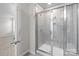Modern tile shower with glass sliding doors and a built-in seat at 2116 Belterra Dr, Charlotte, NC 28216