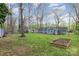 View of a backyard and blue home featuring green grass and a garden at 2156 Flynn Dr, Gastonia, NC 28054