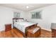 Charming bedroom offers a warm ambiance with hardwood floors and a decorative trunk at 2156 Flynn Dr, Gastonia, NC 28054