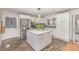 Bright kitchen features a center island, stainless steel appliances, and hardwood floors at 2156 Flynn Dr, Gastonia, NC 28054
