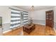 Cozy living room with hardwood floors, a decorative cabinet, and plenty of natural light at 2156 Flynn Dr, Gastonia, NC 28054