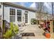 Private back deck featuring furniture, flower pots, and a grill for outdoor gatherings, surrounded by a lush landscape at 2316 Winding River Dr, Charlotte, NC 28214
