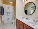 Bathroom with double sinks, new faucets, and a shower with a decorative curtain at 2316 Winding River Dr, Charlotte, NC 28214