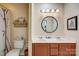 Bathroom with a double vanity with new faucets and a round mirror above at 2316 Winding River Dr, Charlotte, NC 28214