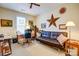Neutral colored bedroom with a leather couch, desk, ceiling fan and a window for natural light at 2316 Winding River Dr, Charlotte, NC 28214