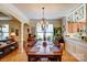 Spacious dining room with hardwood floors, chandelier, and seating for eight at 2316 Winding River Dr, Charlotte, NC 28214