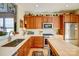 Kitchen features stainless appliances, lots of wood cabinetry, and white countertops at 2316 Winding River Dr, Charlotte, NC 28214