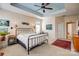 Spacious main bedroom featuring a tray ceiling, ceiling fan, and neutral carpeting at 2316 Winding River Dr, Charlotte, NC 28214