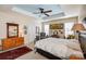 Comfortable main bedroom featuring neutral carpeting, two windows, and a ceiling fan at 2316 Winding River Dr, Charlotte, NC 28214