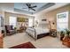 Spacious main bedroom with tray ceiling features a sitting area and a large bed at 2316 Winding River Dr, Charlotte, NC 28214