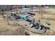 Aerial view of the community playground featuring slides, swings, benches, and sunshades on a well-maintained grounds at 2316 Winding River Dr, Charlotte, NC 28214