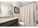 Bathroom with granite vanity, shower with curtain, and neutral color scheme at 2455 Seagull Dr # 62, Denver, NC 28037