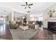 Open-concept living room featuring hardwood floors, neutral paint, and a cozy fireplace at 2455 Seagull Dr # 62, Denver, NC 28037
