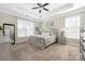 Spacious main bedroom with a tray ceiling, neutral tones, and carpeted floors at 2455 Seagull Dr # 62, Denver, NC 28037