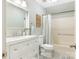 Full bathroom with modern white vanity, updated fixtures, and a shower-tub combination at 2602 Cherokee Ct, Gastonia, NC 28056