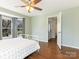 Bright bedroom featuring a ceiling fan, hardwood floors, and a large window for plenty of natural light at 2602 Cherokee Ct, Gastonia, NC 28056
