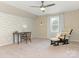 Bedroom featuring a brick accent wall, neutral carpet, chair, and a ceiling fan at 2602 Cherokee Ct, Gastonia, NC 28056