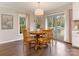 Bright dining room with hardwood floors, backyard views, and modern light fixture creates an inviting space for meals at 2602 Cherokee Ct, Gastonia, NC 28056