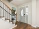 Light-filled foyer with staircase, hardwood floors, and decorative front door provides a welcoming entry to the home at 2602 Cherokee Ct, Gastonia, NC 28056
