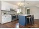 Stylish kitchen with white cabinetry, stainless steel appliances, and an island with seating offers modern convenience at 2602 Cherokee Ct, Gastonia, NC 28056