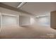 Expansive carpeted basement providing ample open space and lighting at 2835 Peverell Ln, Charlotte, NC 28270