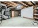 Unfinished basement featuring utilities, exposed ceiling and concrete floor at 2835 Peverell Ln, Charlotte, NC 28270
