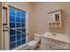 Cozy bathroom with decorative window, grab bars, and traditional vanity at 2835 Peverell Ln, Charlotte, NC 28270