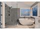 Modern bathroom with large bathtub, glass shower and stylish fixtures at 2835 Peverell Ln, Charlotte, NC 28270