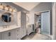 Bathroom with double vanity, large mirrors, storage tower and a private toilet and shower room at 2835 Peverell Ln, Charlotte, NC 28270
