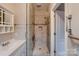 Bright bathroom featuring a glass shower enclosure and elegant fixtures at 2835 Peverell Ln, Charlotte, NC 28270