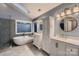 Bathroom with double vanity, bathtub and separate shower showcasing great natural light at 2835 Peverell Ln, Charlotte, NC 28270