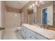 Well-lit bathroom features double sinks, a tub with shower, and neutral tiling at 2835 Peverell Ln, Charlotte, NC 28270