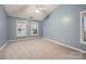 Bedroom with neutral carpet, ceiling fan, and bright windows providing natural light at 2835 Peverell Ln, Charlotte, NC 28270