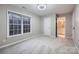 Cozy bedroom offers ample natural light from a large window, with an adjacent bathroom at 2835 Peverell Ln, Charlotte, NC 28270