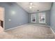 Bedroom with neutral carpet, ceiling fan, windows and door to hallway at 2835 Peverell Ln, Charlotte, NC 28270