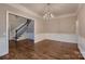 Dining room features hardwood floors, a classic chandelier, and wainscoting at 2835 Peverell Ln, Charlotte, NC 28270