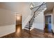 Elegant foyer features hardwood floors, staircase with iron spindles, and a decorative chandelier at 2835 Peverell Ln, Charlotte, NC 28270