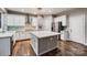 Modern kitchen with a large island, stainless steel appliances, and hardwood floors at 2835 Peverell Ln, Charlotte, NC 28270